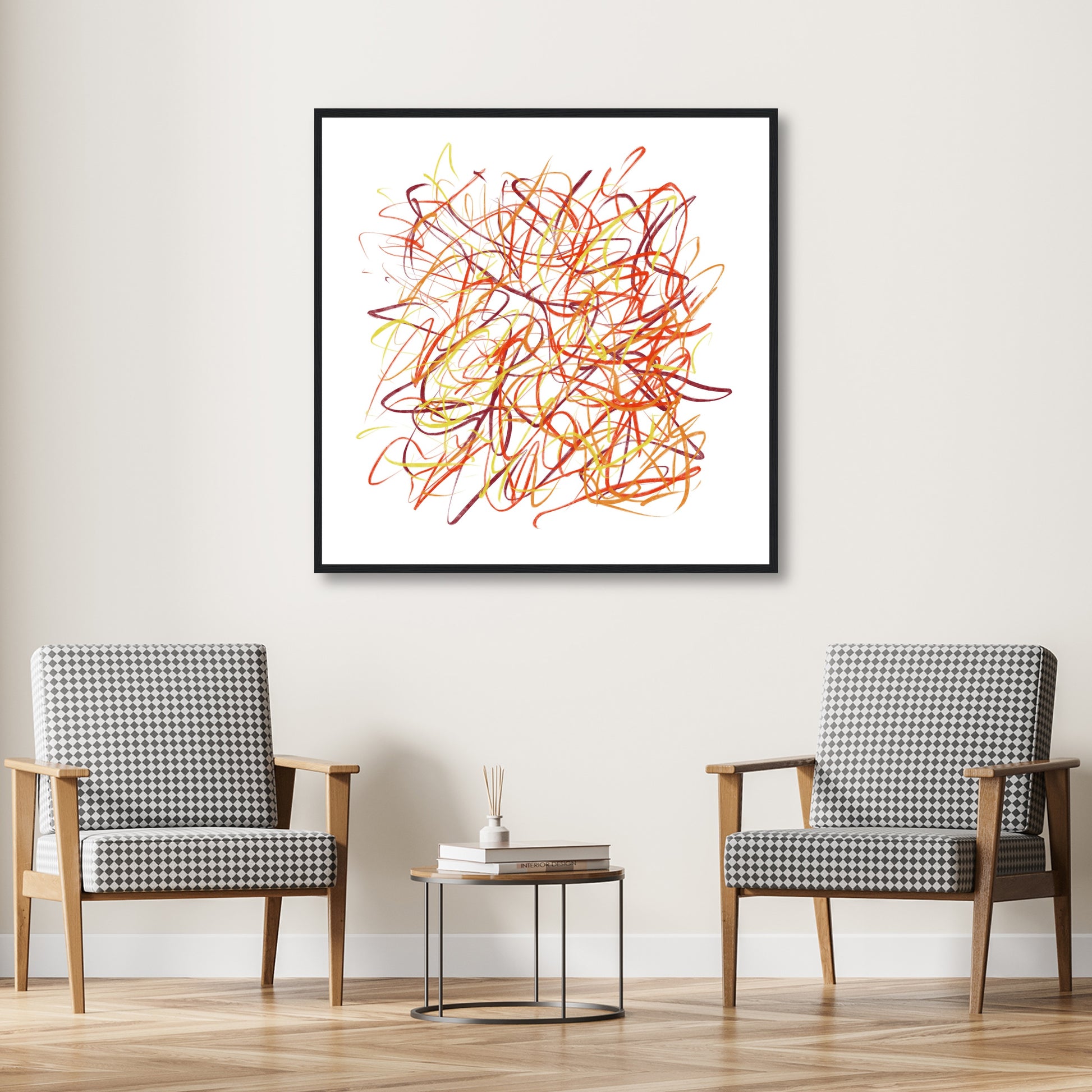 Framed in black, fiery reds and yellows stand out against a white wall with back and white twin chairs below.