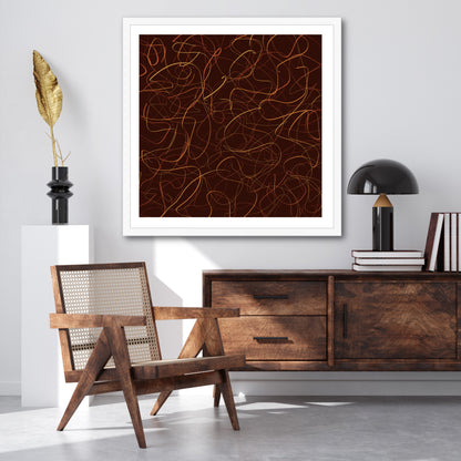 In a white frame the whispy strands of yellow and orange streak across a dark umber background stand out against the grey wall and are complimented by the wooden sideboard with leather-bound books atop..
