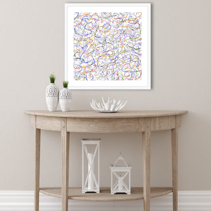 Hanging on a white wall above semi-circular light wood table is 'Skiing' with white frame and mount. Two white vases and an organic bowl accentuate the white snow background of the artwork.